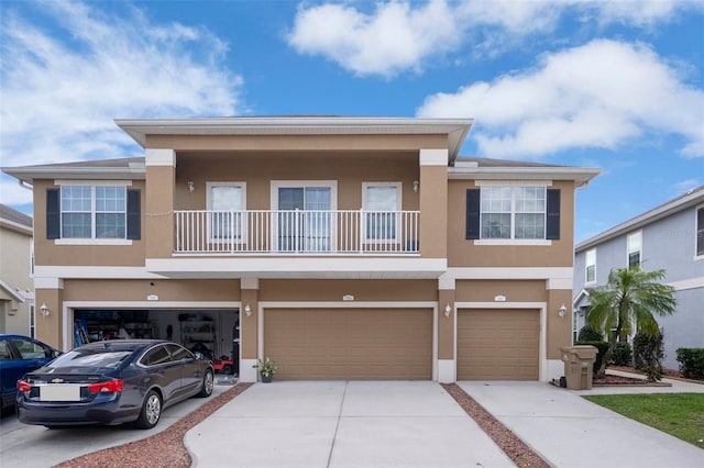 7535 Red Mill Cir, New Port Richey, FL 34653 - view of front of house featuring a garage, driveway, a balcony, and stucco siding