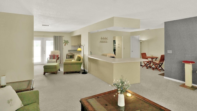 6035 19th St NE, Saint Petersburg, FL 33703 - carpeted living area featuring a textured ceiling and baseboards
