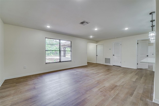 unfurnished room featuring light wood-style flooring, recessed lighting, and visible vents