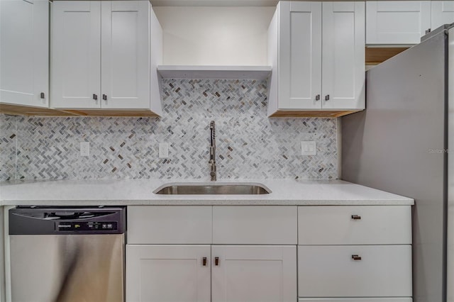 kitchen featuring light countertops, a sink, white cabinets, and dishwasher
