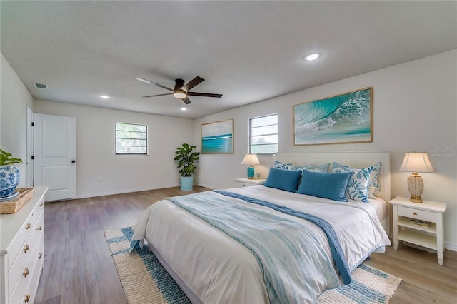 bedroom with a ceiling fan, light wood-style flooring, baseboards, visible vents, and recessed lighting