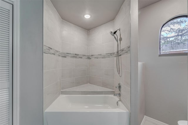 bathroom featuring baseboards and shower / bathtub combination