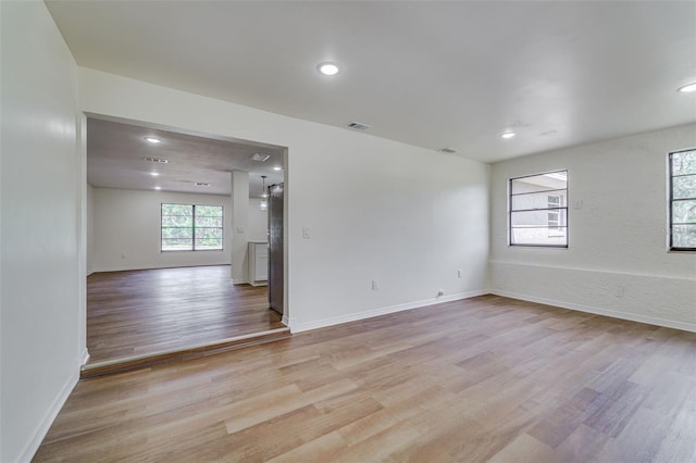 spare room featuring baseboards, visible vents, light wood-style floors, and recessed lighting