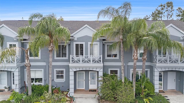 18111 Paradise Point Dr, Tampa, FL 33647 - view of property with stucco siding and a shingled roof