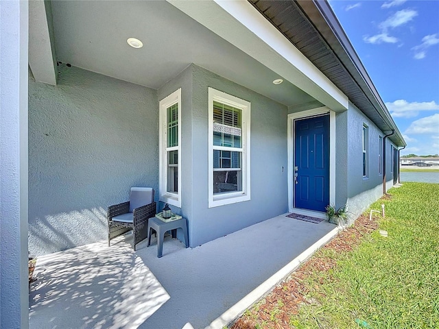 20983 Monza Loop, Land O Lakes, FL 34638 - entrance to property with stucco siding and a porch