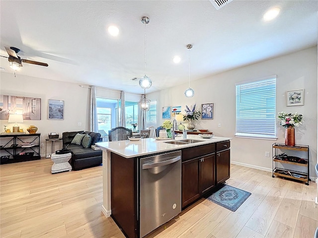 20983 Monza Loop, Land O Lakes, FL 34638 - kitchen featuring stainless steel dishwasher, a sink, light countertops, light wood-type flooring, and open floor plan