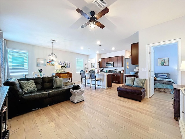 20983 Monza Loop, Land O Lakes, FL 34638 - living room with light wood-type flooring, a ceiling fan, and recessed lighting