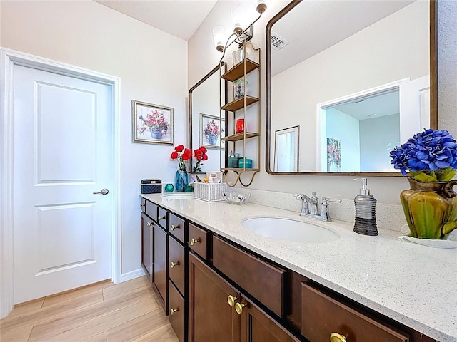 20983 Monza Loop, Land O Lakes, FL 34638 - full bathroom with double vanity and wood finished floors