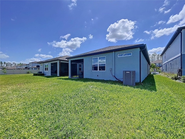 20983 Monza Loop, Land O Lakes, FL 34638 - rear view of house featuring stucco siding, central AC, and a lawn