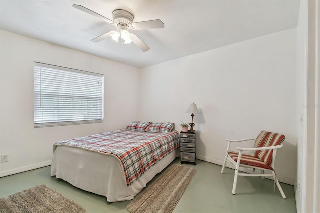 bedroom with baseboards, ceiling fan, and finished concrete floors