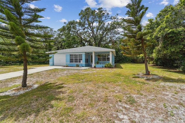 view of front of house featuring an attached garage, concrete driveway, and a front yard