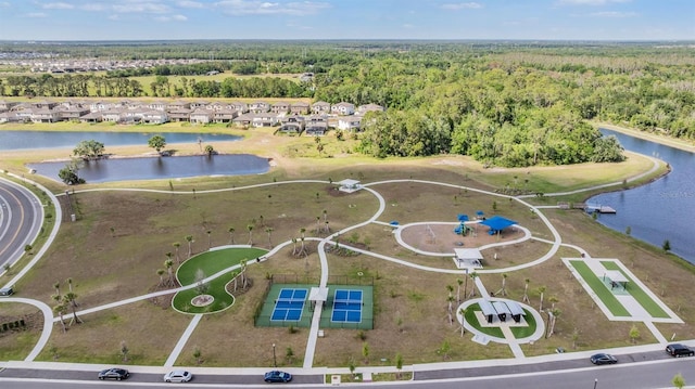 drone / aerial view with a forest view and a water view