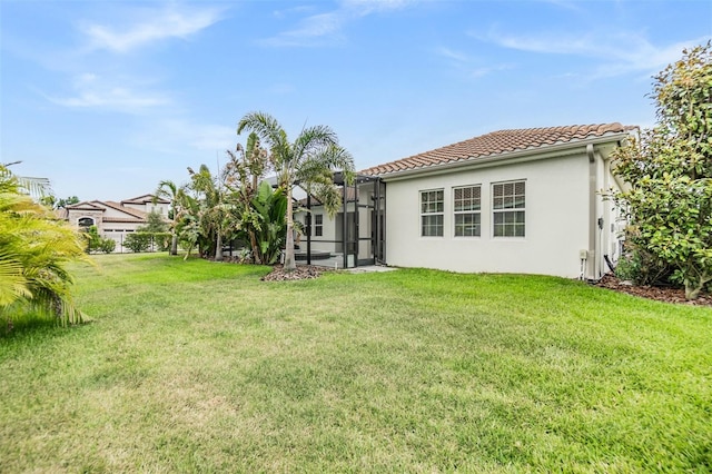 13121 Pasture View Loop, Riverview, FL 33579 - back of house with a tile roof, a yard, stucco siding, and glass enclosure