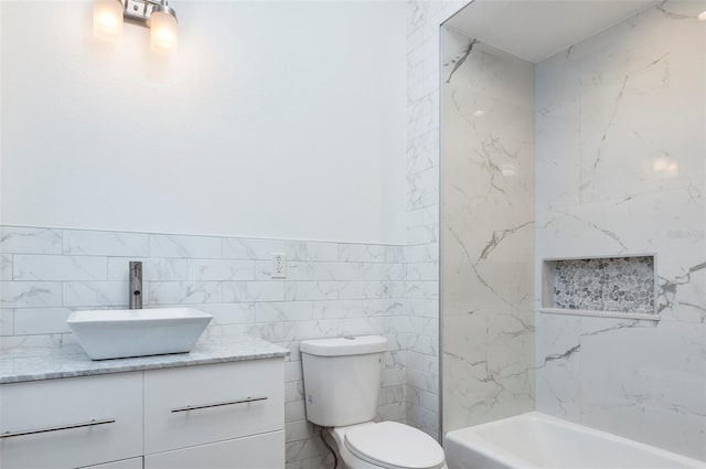 331 Cleveland St Unit 320, Clearwater, FL 33755 - full bathroom with toilet, vanity, a bathtub, walk in shower, and tile walls
