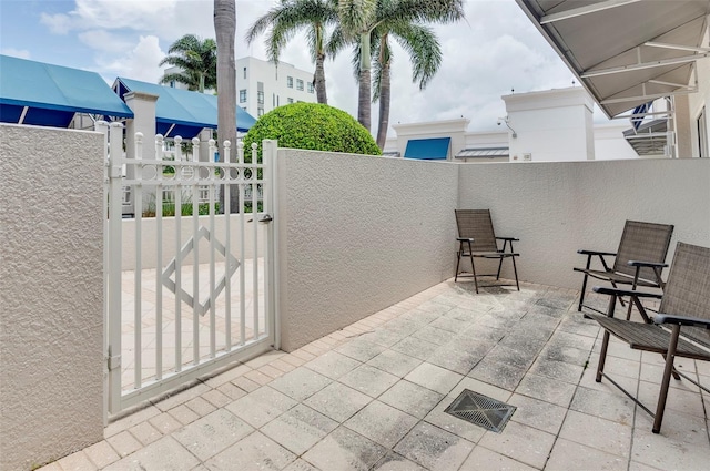 331 Cleveland St Unit 320, Clearwater, FL 33755 - view of patio / terrace featuring a gate, fence, and visible vents