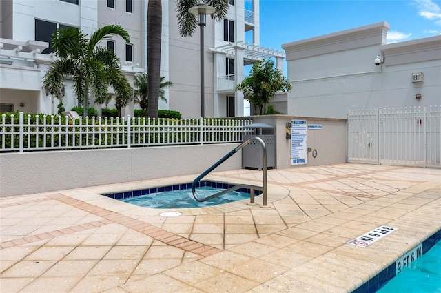 331 Cleveland St Unit 320, Clearwater, FL 33755 - view of pool with a pergola, a patio, fence, and a hot tub