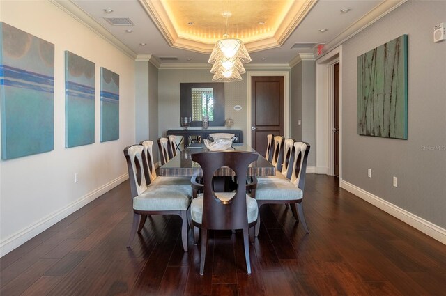 331 Cleveland St Unit 320, Clearwater, FL 33755 - dining space with visible vents, crown molding, baseboards, dark wood-type flooring, and a tray ceiling