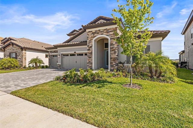 11014 Rustic Timber Loop, San Antonio, FL 33576 - mediterranean / spanish home featuring stucco siding, an attached garage, decorative driveway, and a tiled roof