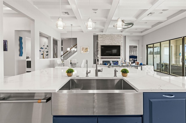 11014 Rustic Timber Loop, San Antonio, FL 33576 - kitchen featuring open floor plan, blue cabinetry, coffered ceiling, beam ceiling, and visible vents
