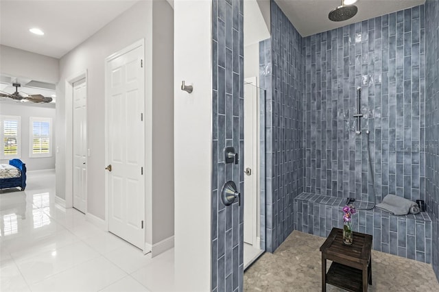 11014 Rustic Timber Loop, San Antonio, FL 33576 - full bathroom featuring baseboards, tile patterned flooring, tiled shower, and ceiling fan