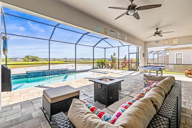 11014 Rustic Timber Loop, San Antonio, FL 33576 - view of patio with glass enclosure, an outdoor living space with a fire pit, a water view, a ceiling fan, and an outdoor pool