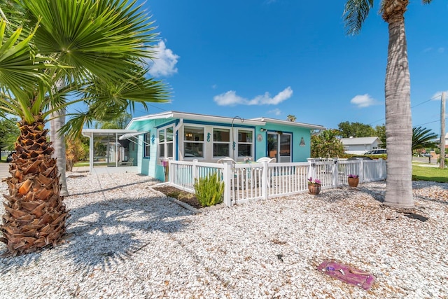 view of front facade featuring a fenced front yard and a carport