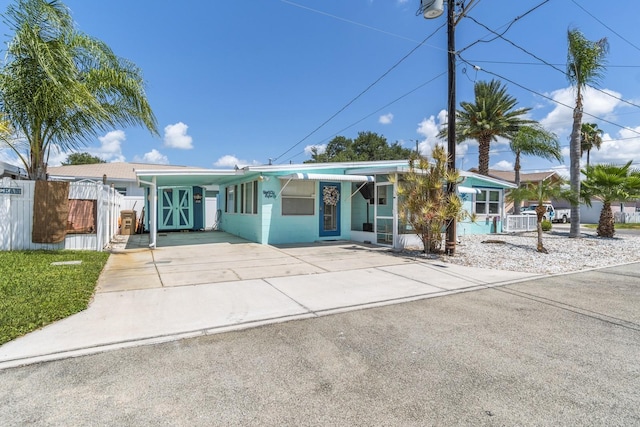 13200 Boca Ciega Ave, Madeira Beach, FL 33708 - view of front of property with concrete driveway and an attached carport