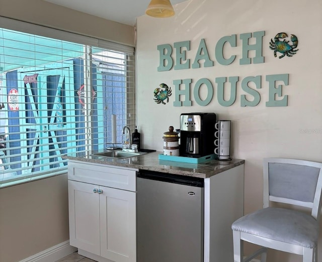 13200 Boca Ciega Ave, Madeira Beach, FL 33708 - indoor wet bar with fridge and baseboards