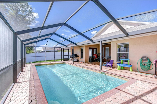 view of pool with a patio area, a ceiling fan, fence, a fenced in pool, and a lanai