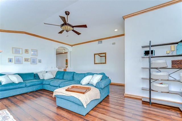 living area featuring baseboards, a ceiling fan, crown molding, visible vents, and wood finished floors