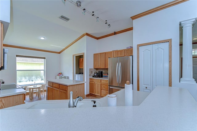 kitchen with crown molding, visible vents, freestanding refrigerator, and separate washer and dryer
