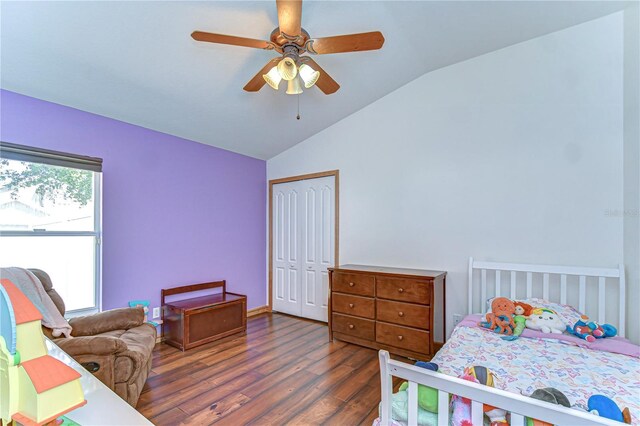 bedroom with wood finished floors, ceiling fan, a closet, and lofted ceiling