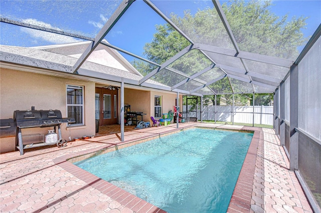 view of pool with a fenced in pool, a patio area, glass enclosure, and fence