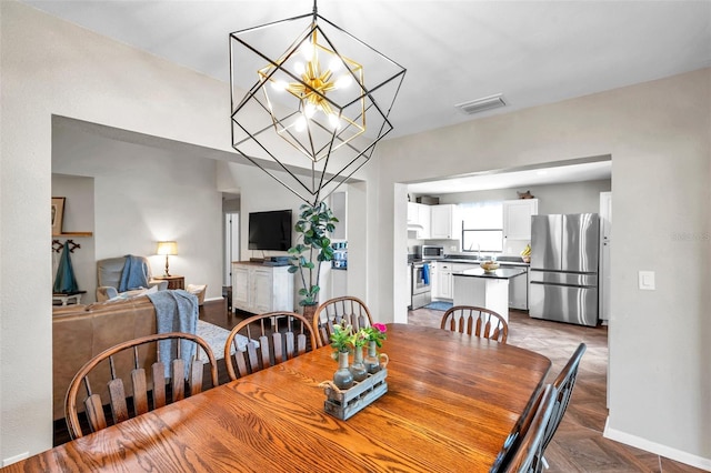 13308 Kearney Way, Tampa, FL 33626 - dining room featuring a notable chandelier, visible vents, and baseboards