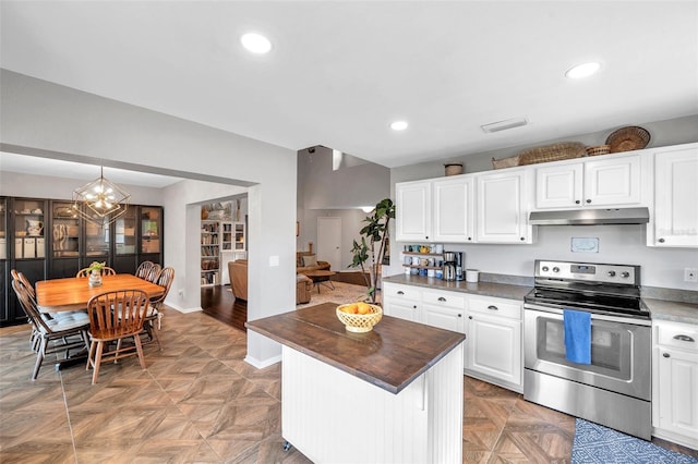 13308 Kearney Way, Tampa, FL 33626 - kitchen featuring white cabinets, under cabinet range hood, visible vents, and stainless steel range with electric cooktop