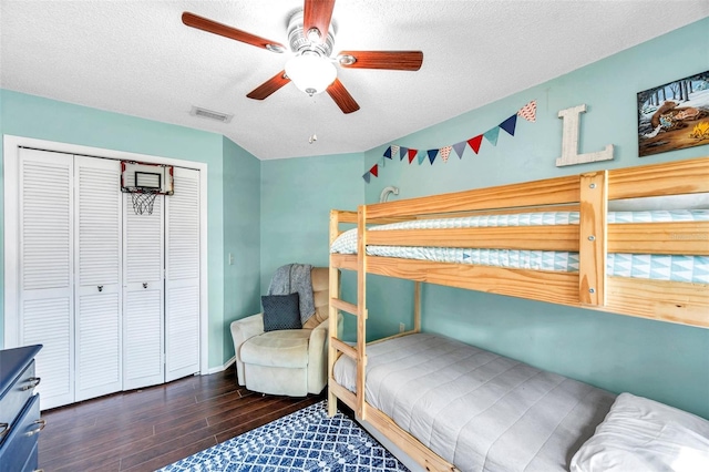 13308 Kearney Way, Tampa, FL 33626 - bedroom featuring a closet, a textured ceiling, a ceiling fan, visible vents, and wood finished floors