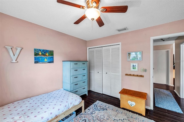 13308 Kearney Way, Tampa, FL 33626 - bedroom featuring visible vents, a closet, a textured ceiling, and dark wood-style floors