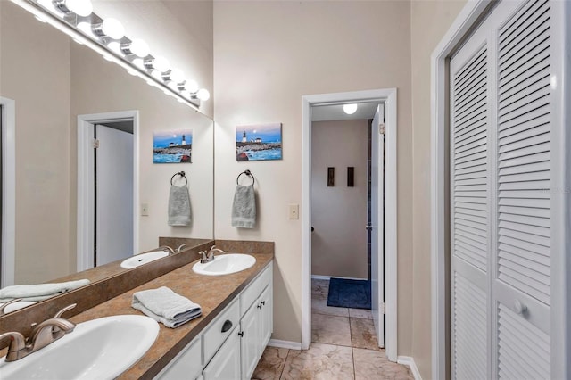13308 Kearney Way, Tampa, FL 33626 - bathroom with a closet, double vanity, a sink, and baseboards