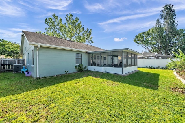13308 Kearney Way, Tampa, FL 33626 - rear view of property featuring a yard, concrete block siding, a sunroom, and fence private yard