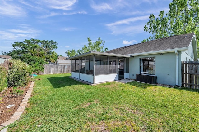 13308 Kearney Way, Tampa, FL 33626 - back of property featuring a sunroom, roof with shingles, a yard, and a fenced backyard