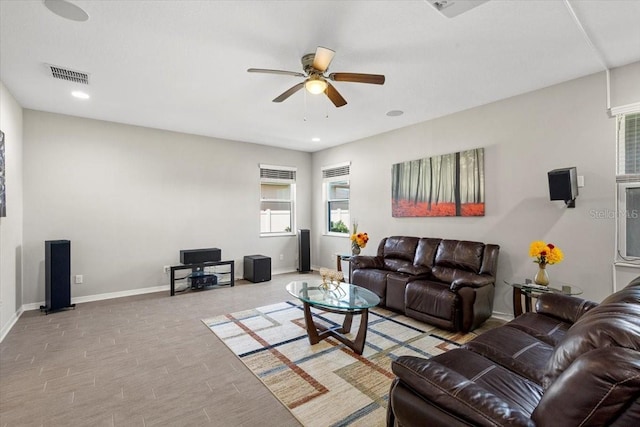 living area featuring recessed lighting, visible vents, baseboards, and ceiling fan