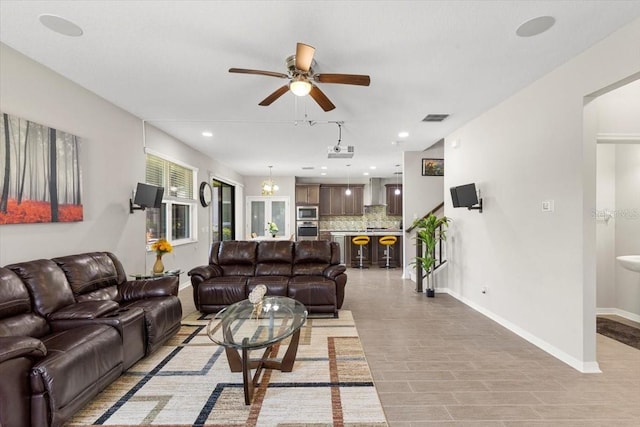living room with ceiling fan, baseboards, visible vents, and recessed lighting