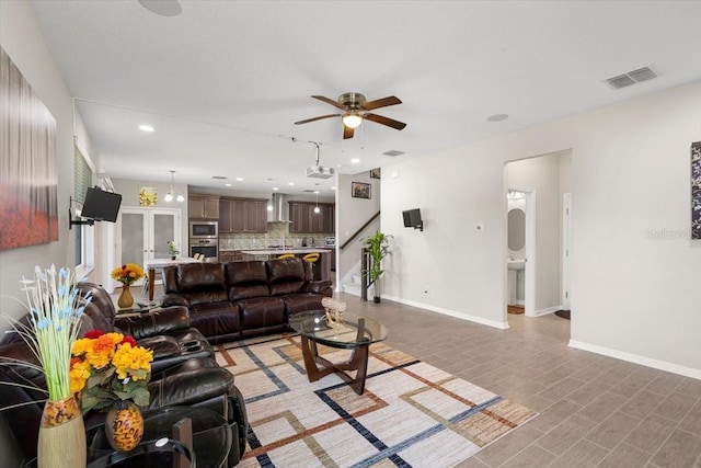 living area featuring visible vents, baseboards, a ceiling fan, recessed lighting, and stairway