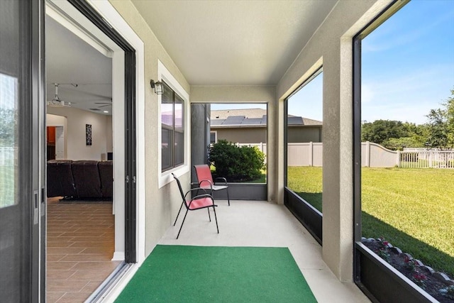 sunroom with a wealth of natural light and a ceiling fan