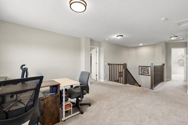 carpeted office with visible vents and baseboards