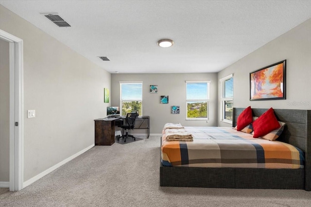 carpeted bedroom with visible vents and baseboards