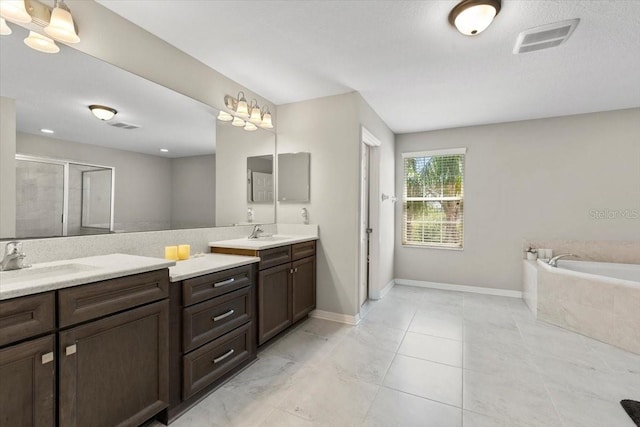 full bath featuring vanity, visible vents, a garden tub, and a stall shower
