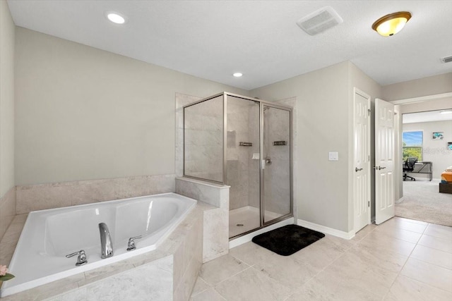 bathroom featuring a shower stall, visible vents, and a garden tub