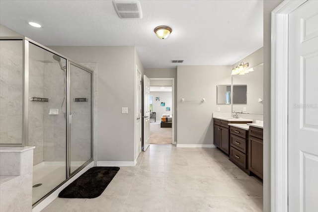 bathroom featuring a shower stall, vanity, ensuite bath, visible vents, and baseboards