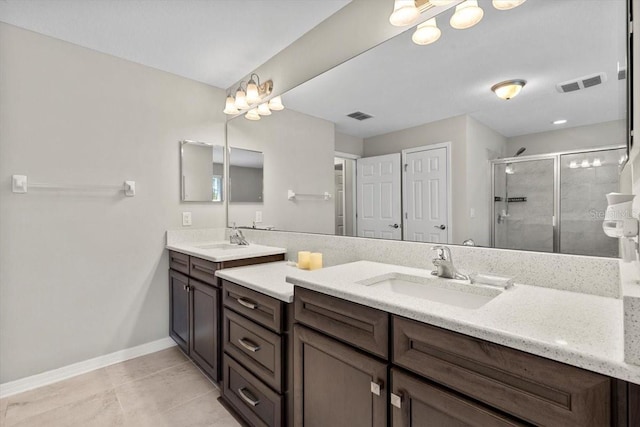 bathroom with visible vents, a sink, and a stall shower